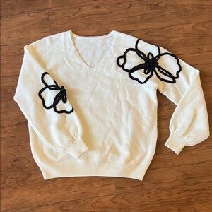 Chic V-Neck Sweater with Black Floral Design